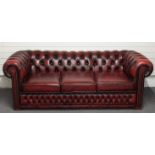 A red leather three seat Chesterfield sofa, length 206cm