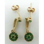 A pair of 9ct gold earrings set with emeralds