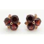 A pair of 9ct gold earrings set with garnets