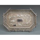 Indian, Burmese or similar white metal tray having central embossed scene of animals and buildings
