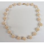 A necklace made up of pearls in clusters with 18ct gold clasp, 22.5cm drop