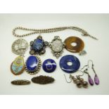 Two silver brooches, a silver pendant, two silver earrings, a silver necklace, a lapis lazuli disc