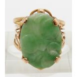 A yellow metal ring set with a carved jadeite plaque, 4.4g, size  L