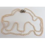 A double strand of cultured pearls with silver clasp