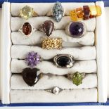 Eleven silver rings set with various gemstones, natural glass, quartz, etc