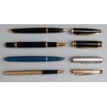 Four various fountain pens comprising two Waterman examples both with black resin barrels and caps