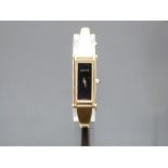 Gucci gold plated ladies wristwatch ref. 1500L with gold hands, black dial and quartz movement, on