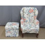 Upholstered blue patterned back armchair and matching footstool