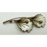 Norwegian silver brooch set with white enamel in the form of two flowers, length 7cm