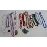 A collection of beaded necklaces including Egyptian, amethyst, agate, etc