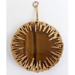 A 9ct gold bespoke pendant set with a circular section of tiger's eye by Hooper Bolton, 37.1g (6cm)