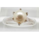 A 14ct white gold ring set with a pearl, 2.9g, size M