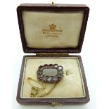 Georgian/Victorian mourning brooch set with plaited hair to the central glass compartment surrounded