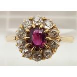 Victorian 18ct gold ring set with an oval cut ruby surrounded by old cut diamonds, 3.3g, size N