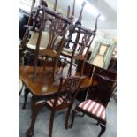 A mahogany extending dining table and eight chairs, all raised on ball and claw feet, W58 x H73 x