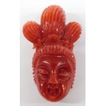 Chinese carved coral figure in the form of a lady's head, 3.5cm long.