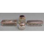 Three hallmarked silver lidded cut glass dressing table pots, length of longest 11cm, and a