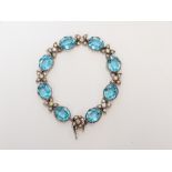 A silver 1950s bracelet set with blue and clear paste