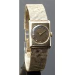 Omega 9ct gold ladies wristwatch with gold hands and baton markers, tropical brown dial and signed