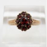 A 9ct gold ring set with garnets, Birmingham 1966, 2.3g, size P