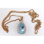 A 9ct gold pendant set with a pear cut topaz surrounded by diamonds, 4.4g