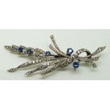 Silver brooch set with paste and sapphires in a floral design, 8 x 3.5cm