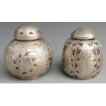 Two white metal overlaid lidded coconut jars with embossed detail, tallest 13.5cm