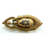 Victorian Etruscan Revival yellow metal brooch set with a pearl to the centre surrounded by a blue