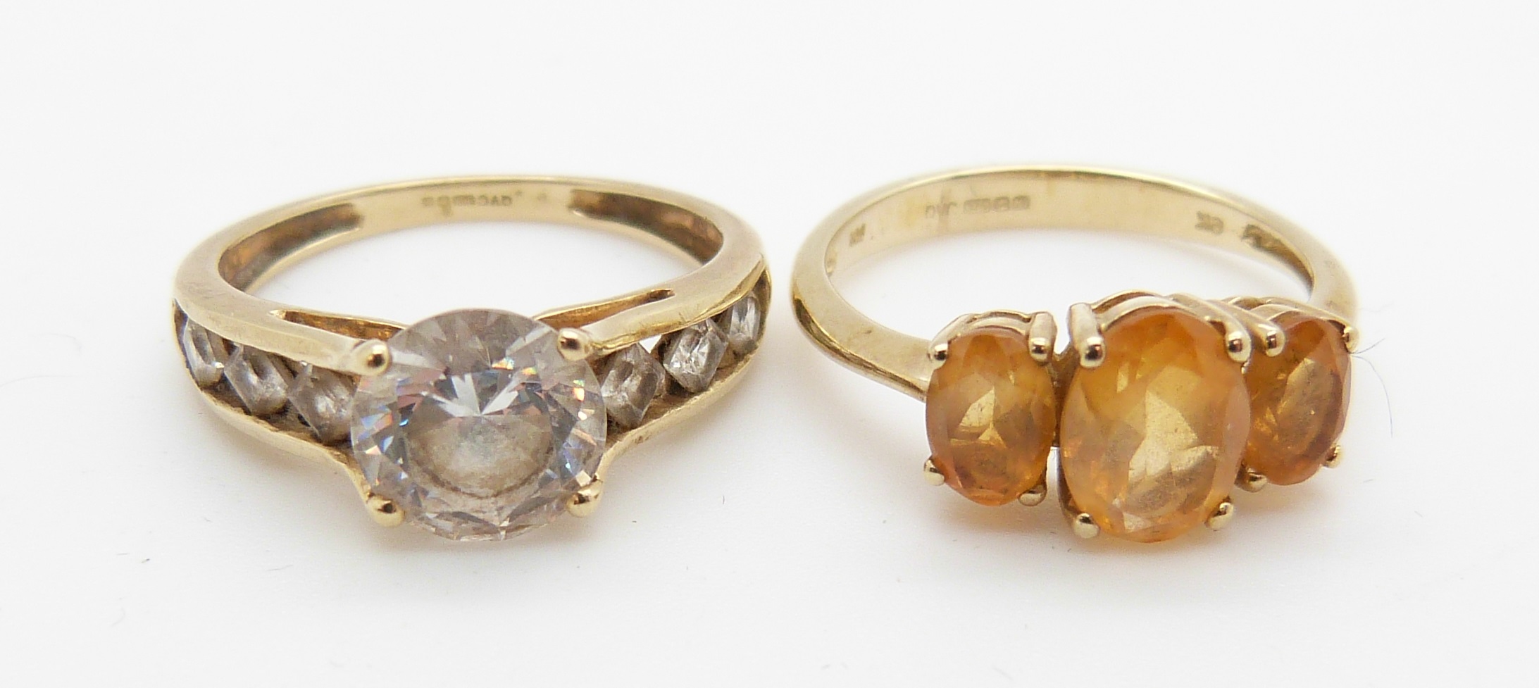 A 9ct gold ring set with topaz and a 9ct gold ring set with cubic zirconia, 5.7g