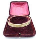 A 9ct rose gold bangle in original box, 8.9g