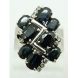 A white metal ring set with eight oval cut sapphires and diamonds, 10.1g, size U