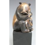 Bronze and gilt figure of a panda eating bamboo, initialled verso GK 91-5, height 15.5cm