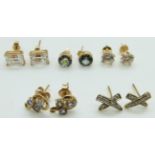 Two pairs of 14k gold studs/ earrings set with cubic zirconia, a pair of 14k gold studs set with