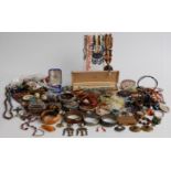 A collection of costume jewellery including amber brooch, compacts, bangles, agate necklace, vintage