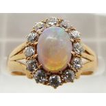 Edwardian 18ct gold ring set with an oval opal cabochon surrounded by diamonds, Birmingham 1901, 4.