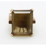 A 9ct gold ring set with a large emerald cut quartz, 11.2g, size M