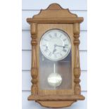 Light oak three train German wall clock with Roman dial, striking the quarters on chimes, 50cm tall