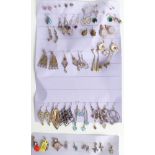 A collection of silver earrings including tiger's eye, quartz, turquoise, opal, and four silver