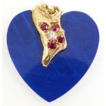 An 18ct gold pendant set with faux lapis lazuli, an oval cut diamond of approximately 0.2ct and four