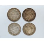 Four George V half crowns dated 1914, 1915, 1916 and 1918