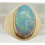 A 14k gold ring set with an oval opal cabochon, 4.4g, size L