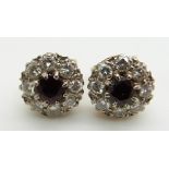 A pair of 9ct gold earrings set with garnets and diamonds