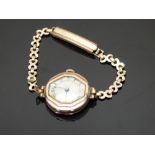 9ct gold ladies wristwatch with blued hands, black Arabic numerals, silver dial, bevelled bezel