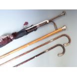 Five hallmarked silver mounted walking sticks and canes including malacca, military swagger stick
