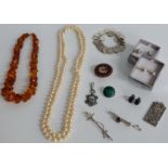 A collection of jewellery including pressed amber necklace, silver and marcasite pendant,