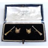 A pair of Victorian cufflinks in the form of fox's heads and hunting horns, set with sapphire eyes
