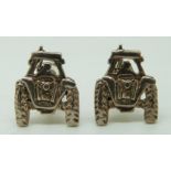 A pair of silver cufflinks in the form of tractors