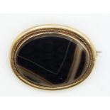 Victorian yellow metal brooch set with agate within a rope twist border, 11.5g, 3.6 x 3cm