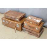 Five vintage leather suitcases, largest W82cm
