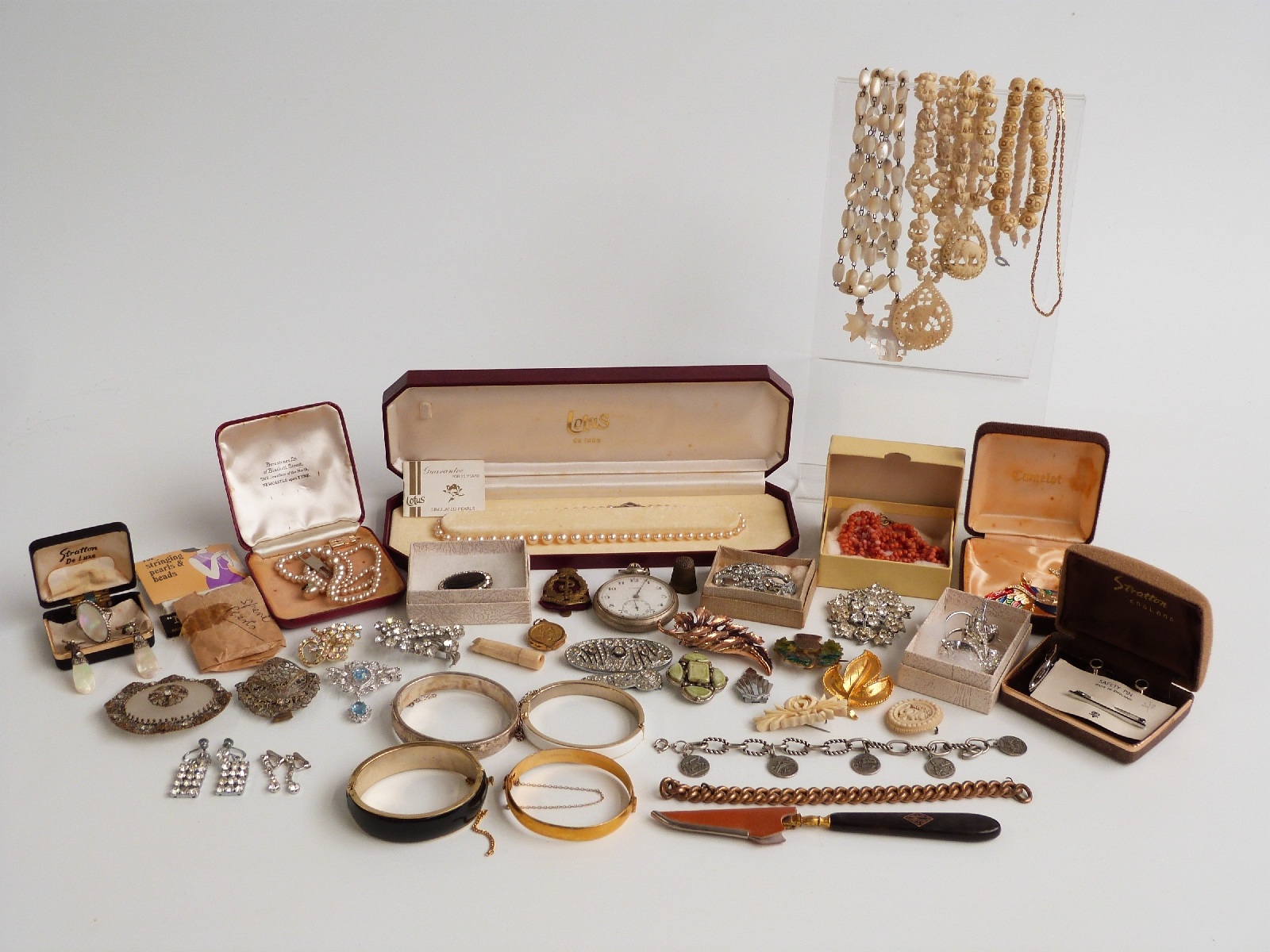 A collection of costume jewellery including brooches, necklaces, paste jewellery, silver bangle,